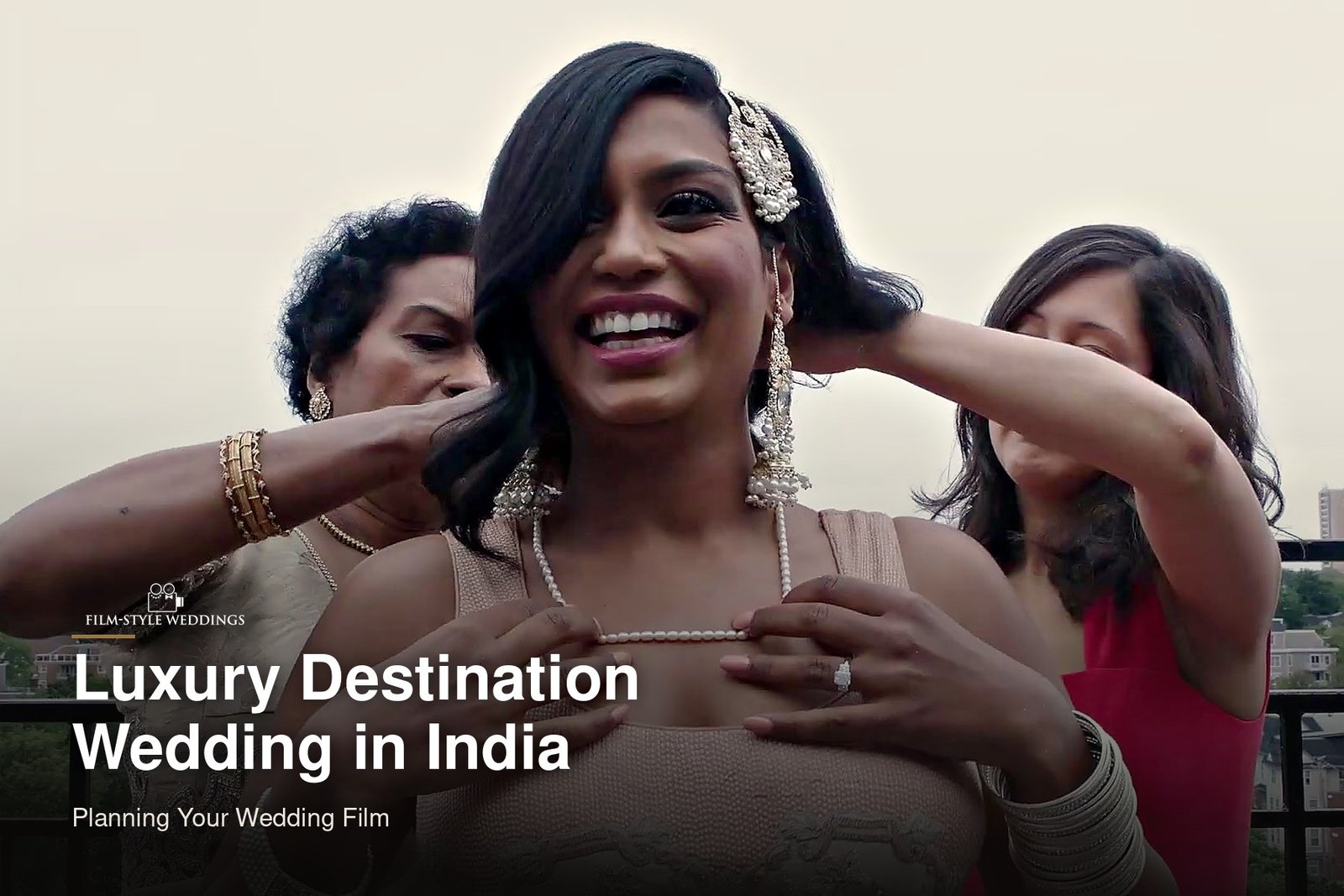 Luxury destination wedding India guide cover: a smiling bride as her jewellery is placed