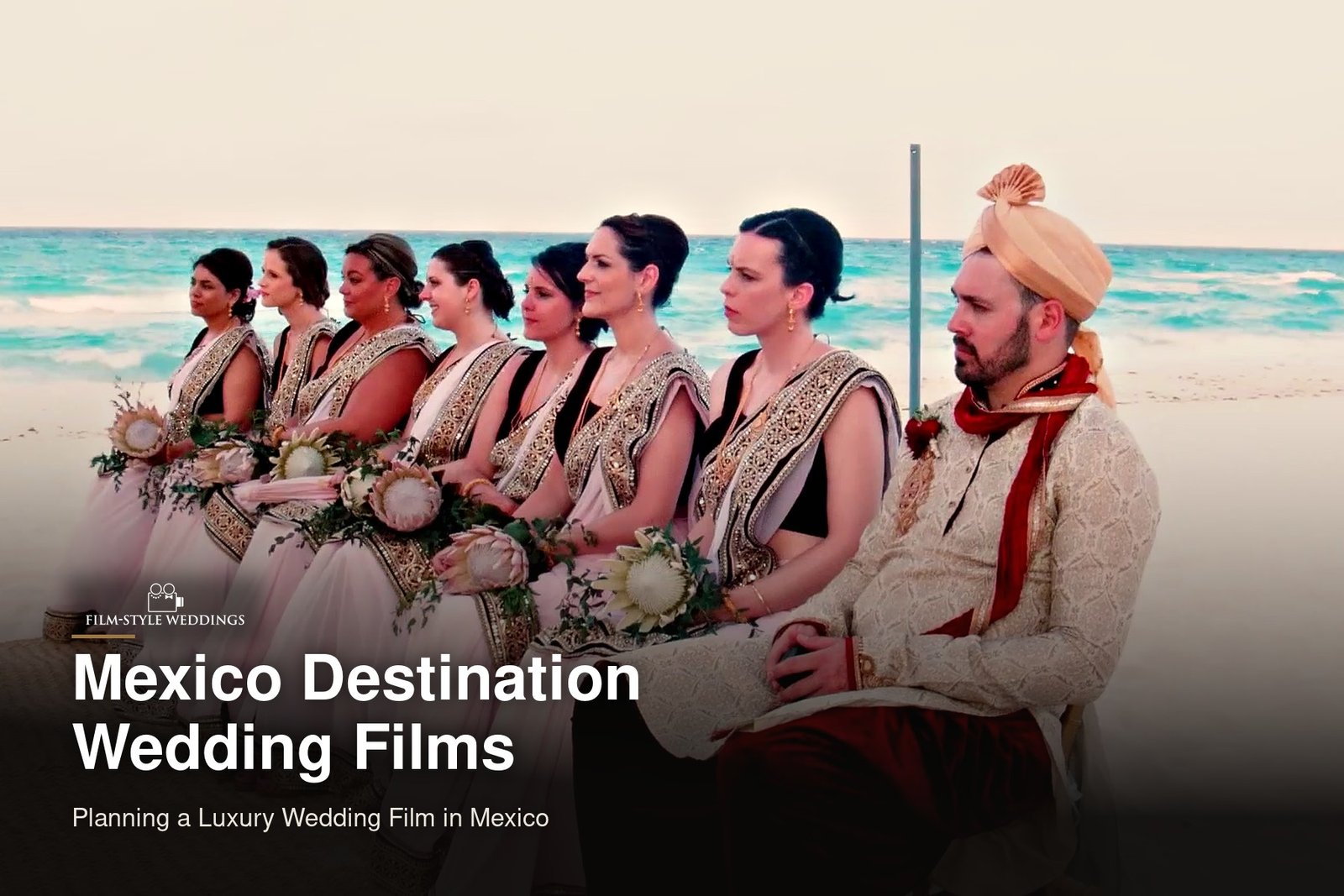 Mexico destination wedding guide cover: the wedding party seated at a beach ceremony by the sea, from our destination wedding film in Mexico