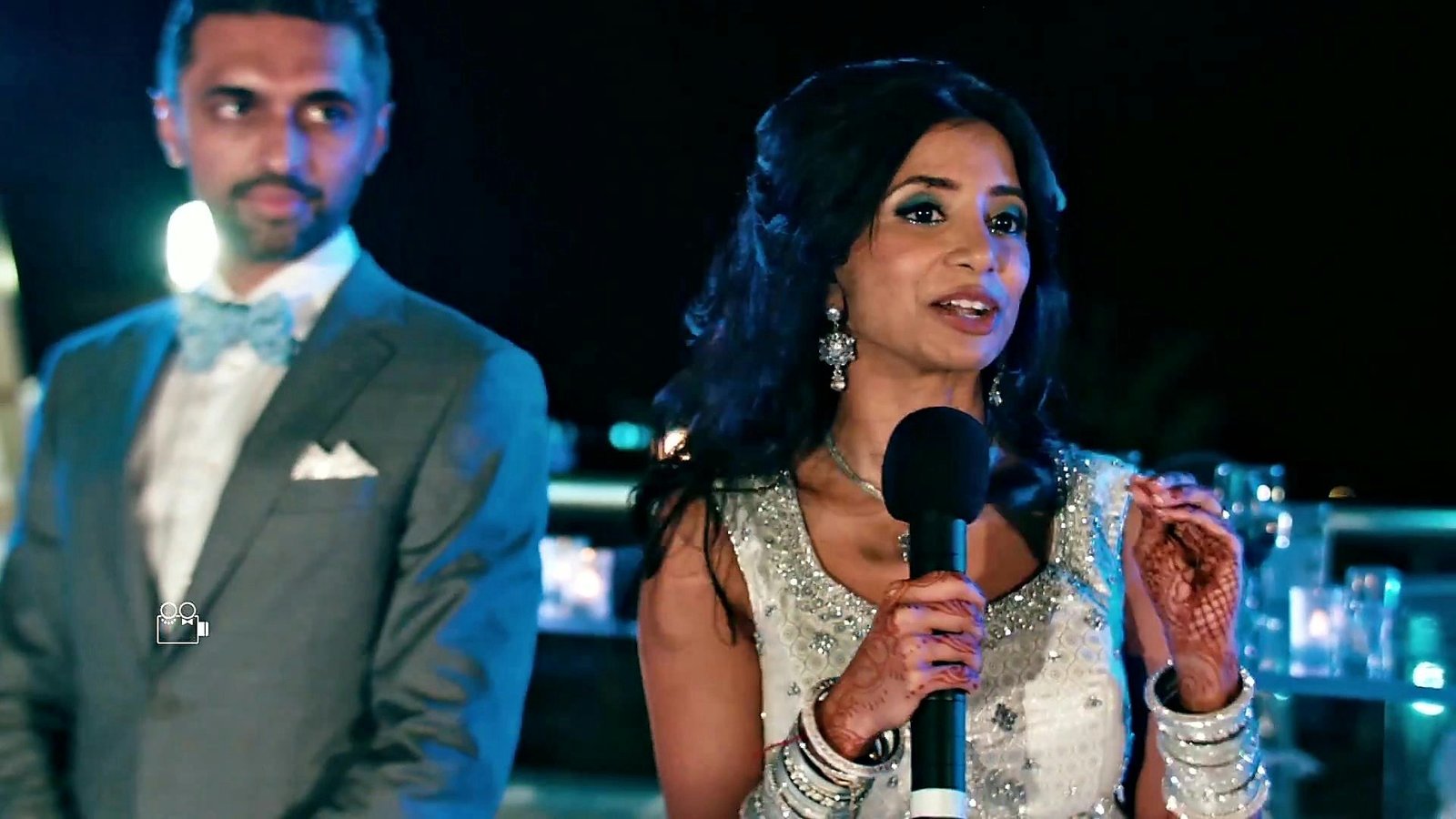 Destination wedding film still of Neema giving a toast beside Franky at their wedding in Mexico