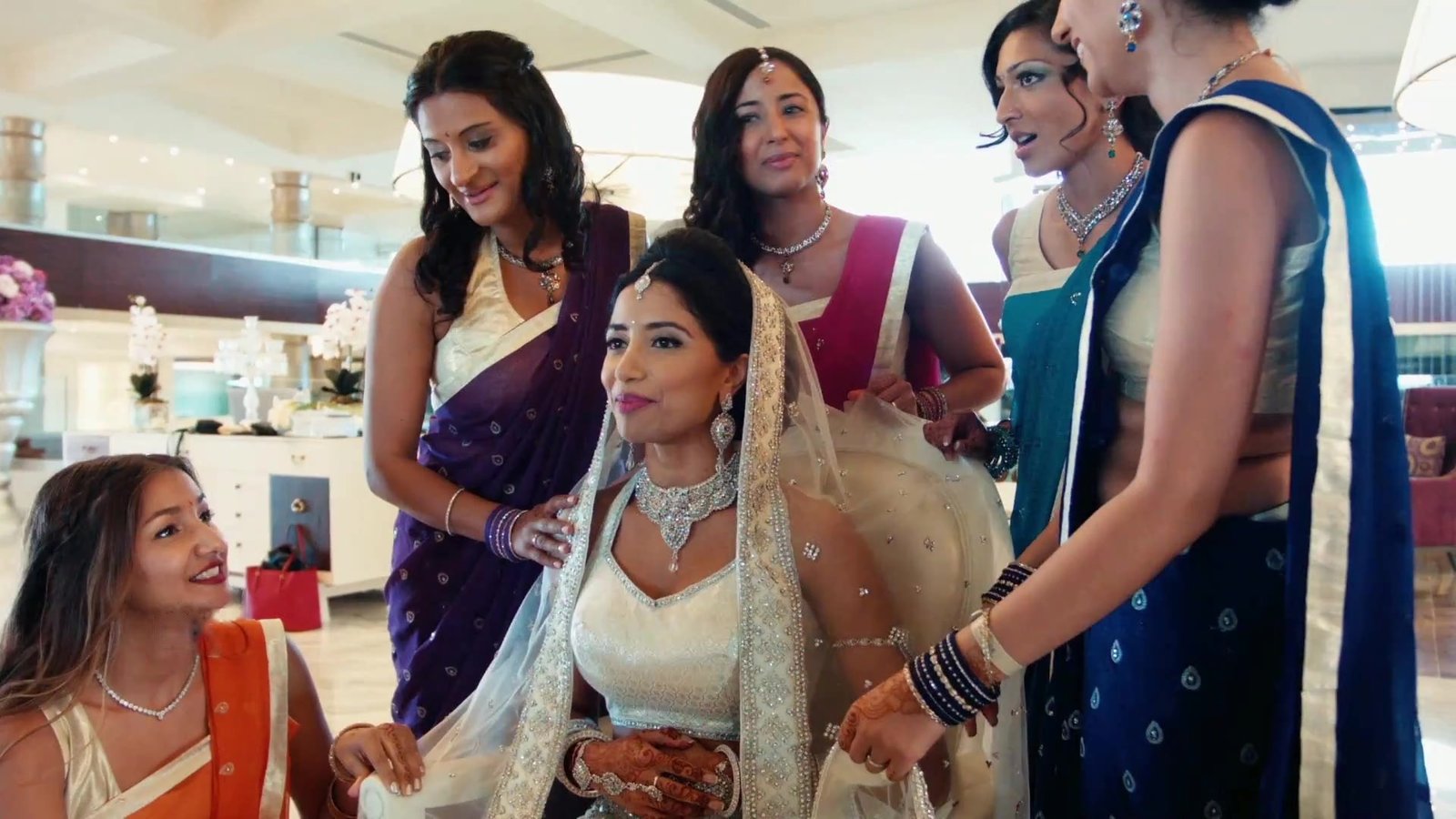 Lake Como destination wedding planning guide: a bride getting ready with her bridesmaids, from Franky and Neema's destination wedding film