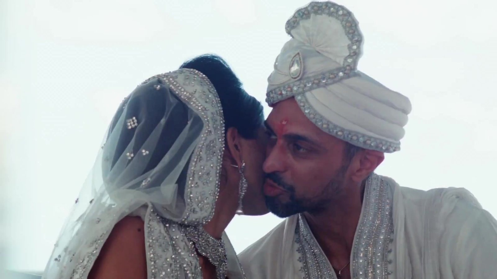 Lake Como destination wedding film inspiration: a groom kisses his bride during the ceremony, from Franky and Neema's destination wedding film
