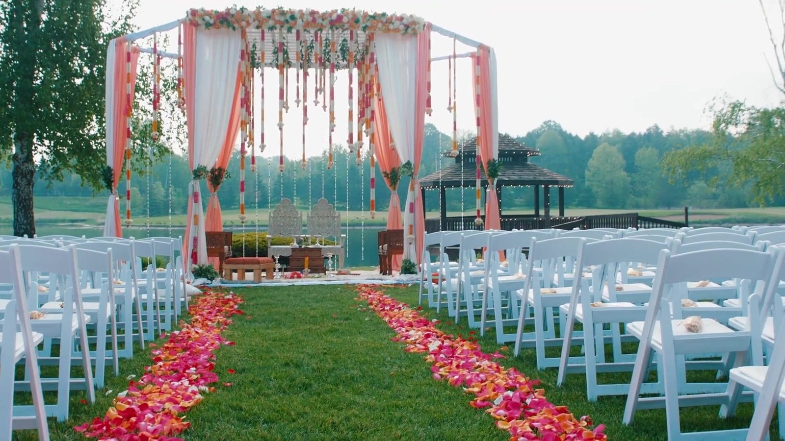 Luxury wedding in Australia inspiration: an outdoor ceremony aisle lined with rose petals and white chairs, from our wedding film Samantha + Roger