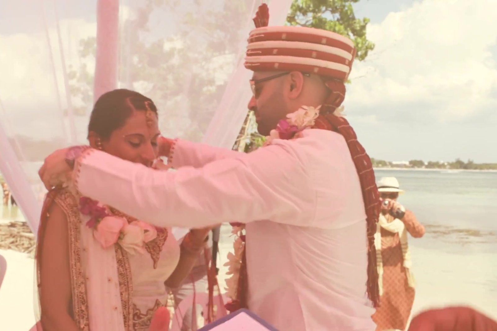 Santorini destination wedding planning guide: a joyful ceremony moment by the water, from our destination wedding film in Jamaica