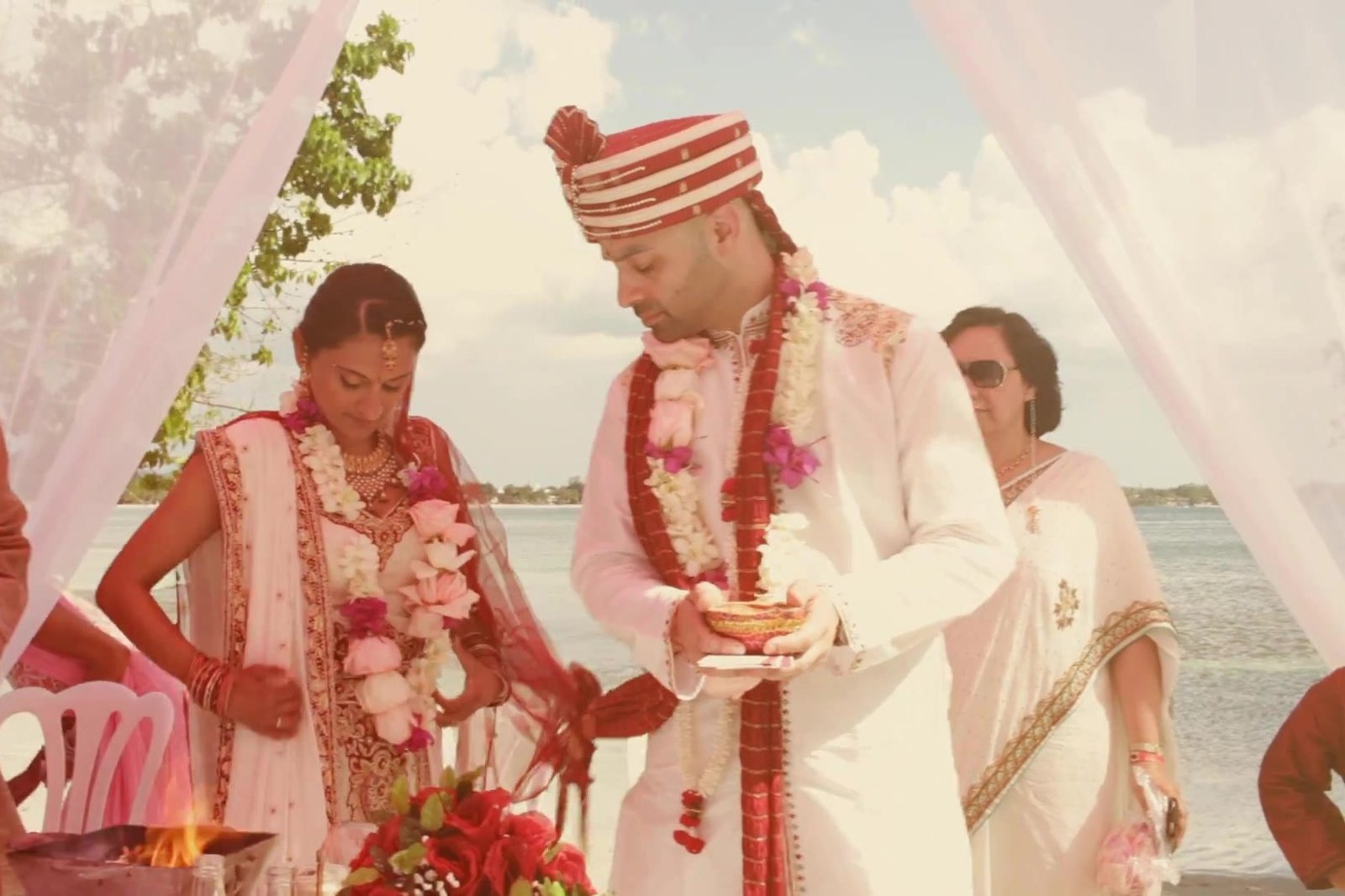 Santorini destination wedding film inspiration: a seaside ceremony under a white canopy, from our destination wedding film in Jamaica