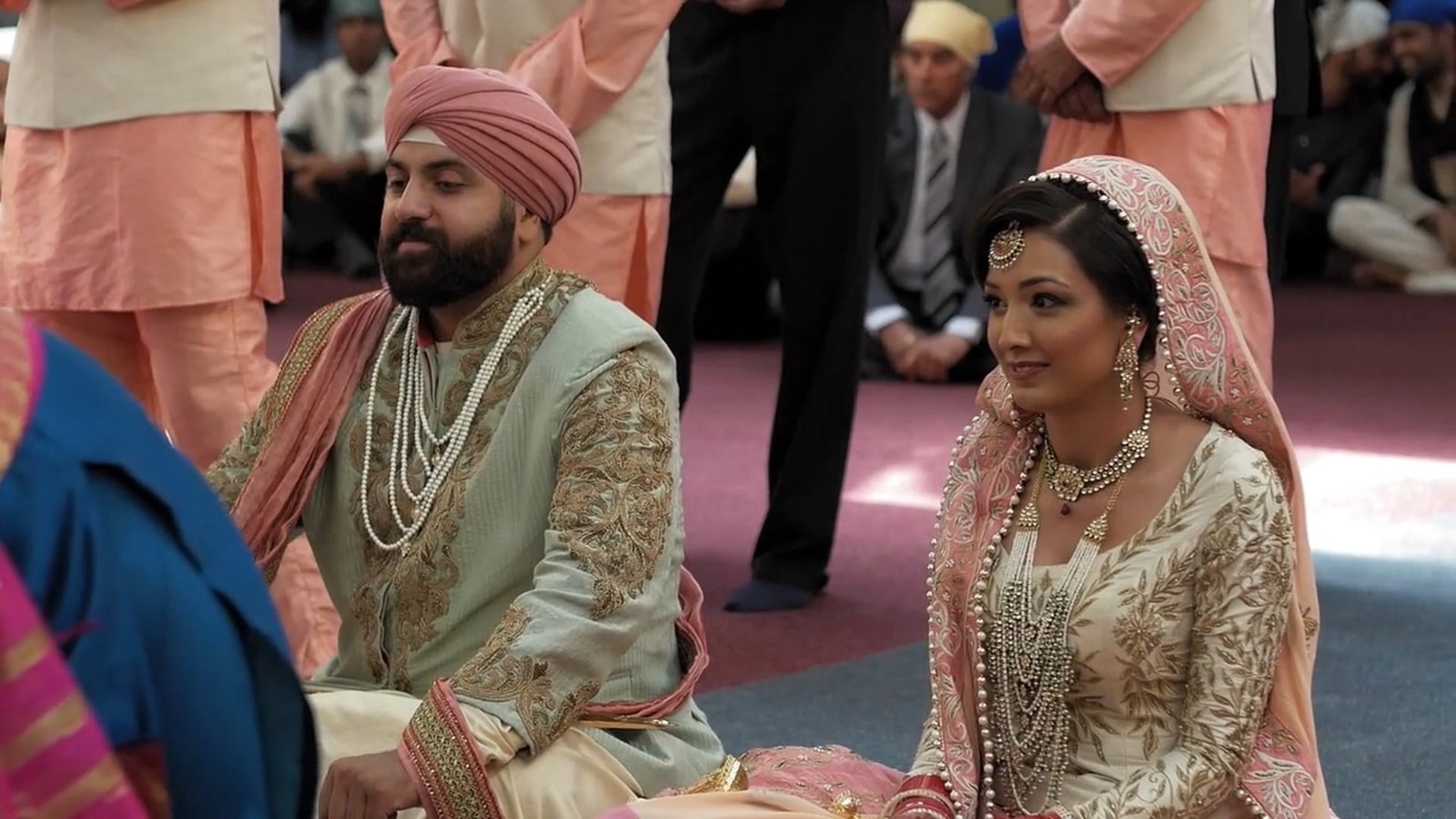 Same day edit wedding film still of CK and Robin seated together during their wedding ceremony